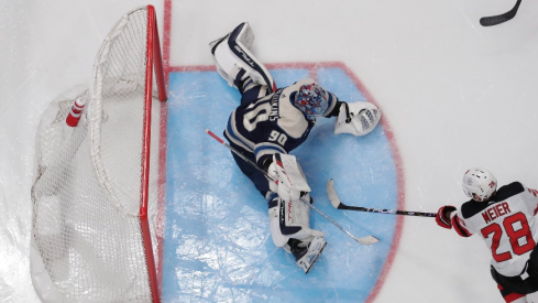 Columbus Blue Jackets goalie Elvis Merzlikins (90) makes a pad save on the shot form New Jersey Devils right wing Timo Meier (28) during the second period at Nationwide Arena.