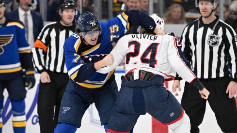 Columbus Blue Jackets right wing Mathieu Olivier (24) fights St. Louis Blues defenseman Tyler Tucker (75) during the second period at Enterprise Center.