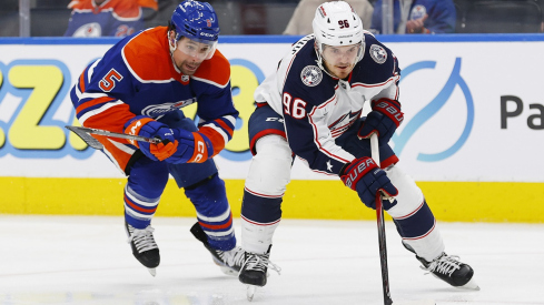 Cody Ceci tries to knock the puck away from Columbus Blue Jackets forward Jack Roslovic