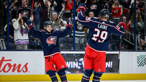 Columbus Blue Jackets left wing Johnny Gaudreau (13) celebrates his game winning goal against the Los Angeles Kings with Columbus Blue Jackets left wing Patrik Laine (29) in overtime at Nationwide Arena.