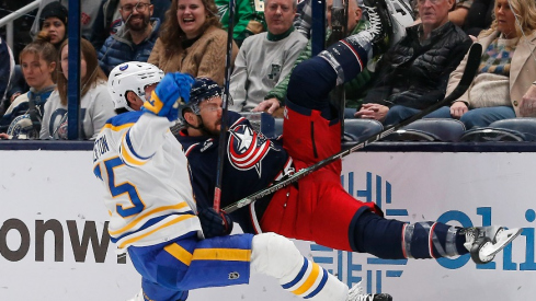 Buffalo Sabres defenseman Connor Clifton (75) checks Columbus Blue Jackets center Sean Kuraly (7) during the first period at Nationwide Arena.