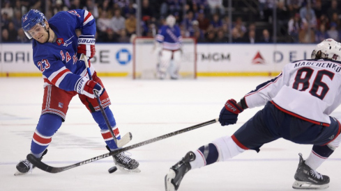 New York Rangers defenseman Adam Fox (23) takes a shot against Columbus Blue Jackets right wing Kirill Marchenko (86) during the second period at Madison Square Garden.