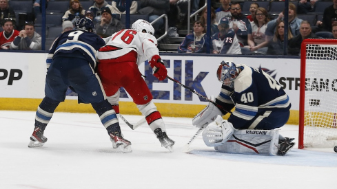 Carolina Hurricanes' Brady Skjei slides the puck through the pads of Columbus Blue Jackets' Daniil Tarasov for a gaol during the second period at Nationwide Arena.