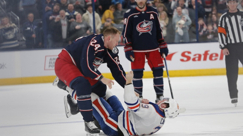 Columbus Blue Jackets' Mathieu Olivier and Edmonton Oilers' Sam Carrick fight during the first period at Nationwide Arena.