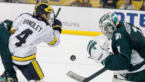 Michigan State goaltender Trey Augustine makes a save against Michigan right wing Gavin Brindley during the third period at Yost Ice Arena in Ann Arbor on Friday, Feb. 9, 2024.