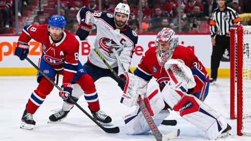 Montreal Canadiens goalie Cayden Primeau (30) tracks the play beside defenseman Mike Matheson (8) and Columbus Blue Jackets center Boone Jenner (38) during the second period at Bell Centre.