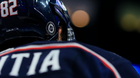 The NHL Unity and Equality sticker on the helmet of Columbus Blue Jackets left wing Mikael Pyyhtia (82) is seen as he skates during warmups prior to the game against the Buffalo Sabres at Nationwide Arena.