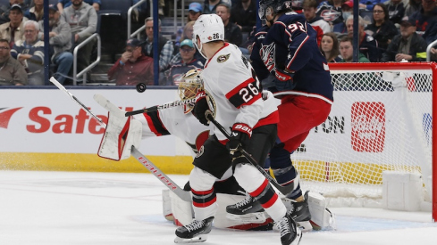 Ottawa Senators' Anton Forsberg makes a blocker save as Columbus Blue Jackets' Alexander Nylander looks for a rebound during the first period at Nationwide Arena.