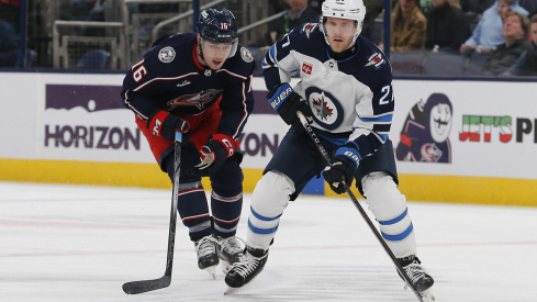 Winnipeg Jets left wing Nikolaj Ehlers carries the puck in front of Brendan Gaunce