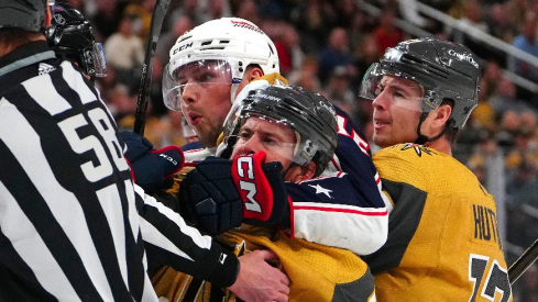 Columbus Blue Jackets center Brendan Gaunce (16) grabs ahold of Vegas Golden Knights right wing Jonathan Marchessault (81) as Vegas Golden Knights defenseman Ben Hutton (17) joins the play during the first period at T-Mobile Arena.