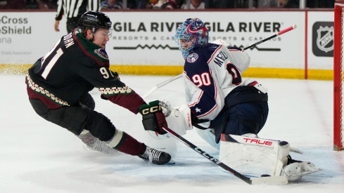 Columbus Blue Jackets goaltender Elvis Merzlikins (90) makes the save on Arizona Coyotes right wing Josh Doan (91) in the second period at Mullett Arena.