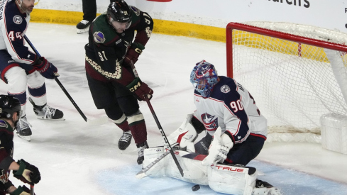 Columbus Blue Jackets goaltender Elvis Merzlikins makes a save on Arizona Coyotes right wing Josh Doan