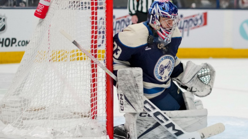 Columbus Blue Jackets goaltender Jet Greaves (73) reacts as the puck deflects off his mask while defending the net against the New York Islanders in the third period at Nationwide Arena.