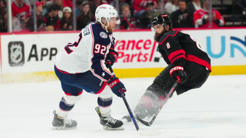 Columbus Blue Jackets' Alexander Nylander holds onto the puck against Carolina Hurricanes' Brent Burns during the first period at PNC Arena.
