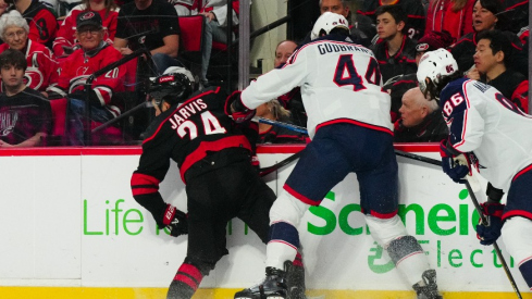 Columbus Blue Jackets defenseman Erik Gudbranson (44) checks Carolina Hurricanes center Seth Jarvis (24) during the first period at PNC Arena.