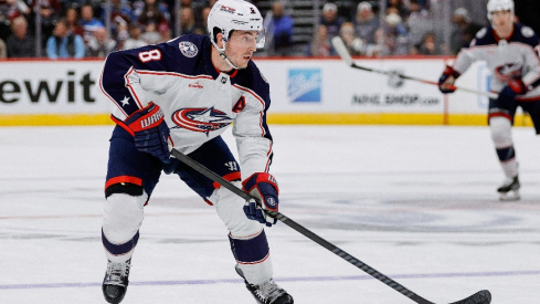 Columbus Blue Jackets defenseman Zach Werenski (8) controls the puck in the third period against the Colorado Avalanche at Ball Arena.