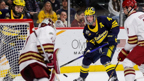 Michigan forward Gavin Brindley (4) shoots the puck against Boston College goaltender Jacob Fowler (1) during the first period of the Frozen Four semifinal game at Xcel Energy Center in St. Paul, Minn. on Thursday, April 11, 2024.