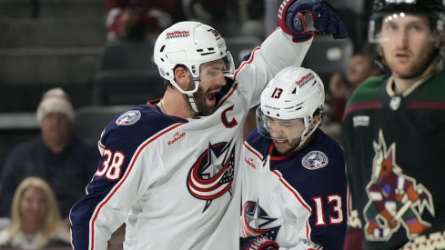Columbus Blue Jackets center Boone Jenner (38) celebrates with left wing Johnny Gaudreau (13) after scoring a goal against the Arizona Coyotes in the first period at Mullett Arena.