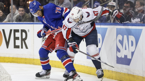 New York Rangers defenseman K'Andre Miller and Washington Capitals left wing Beck Malenstyn battle for control of the puck in game one of the first round of the 2024 Stanley Cup Playoffs