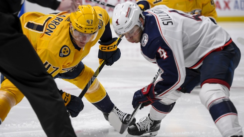 Nashville Predators right wing Michael McCarron (47) and Columbus Blue Jackets center Cole Sillinger (4) face off during the third period at Bridgestone Arena.