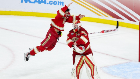 Denver Pioneers defenseman Zeev Buium (28) and goaltender Matt Davis (35) celebrate their teams win against the Boston College Eagles after the championship game of the 2024 Frozen Four college ice hockey tournament at Xcel Energy Center.