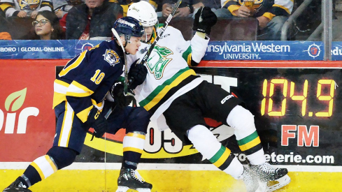 London Knights defenseman Sam Dickinson battles for a puck 