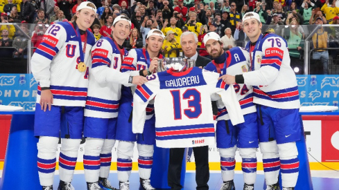 USA hockey poses with Johnny Gaudreau's jersey and the championship trophy after Sunday's 1-0 overtime win over Switzerland.