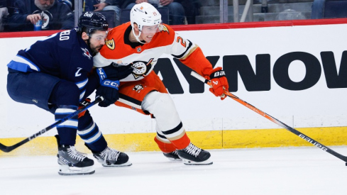 Anaheim Ducks forward Isac Lundestrom (21) tries to skate away from Winnipeg Jets defenseman Dylan DeMelo (2) during the first period at Canada Life Centre.