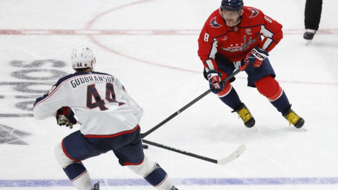 Washington Capitals left wing Alex Ovechkin (8) skates with the puck as Columbus Blue Jackets defenseman Erik Gudbranson (44) defends in the third period at Capital One Arena.