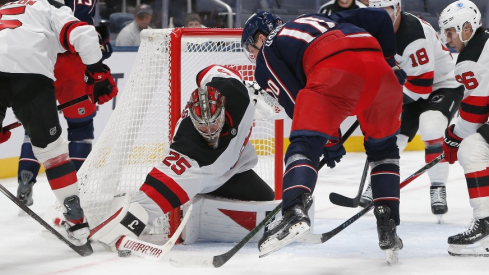 Oct 13, 2025; Columbus, Ohio, USA; New Jersey Devils goalie Jacob Markstrom (25) makes a stick save as Columbus Blue Jackets left wing Dmitri Voronkov (10) looks for a rebound during the third period at Nationwide Arena.