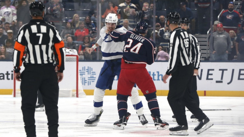 Oct 18, 2025; Columbus, Ohio, USA; Tampa Bay Lightning center Curtis Douglas (42) and Columbus Blue Jackets center Mathieu Olivier (24) fight during the first period at Nationwide Arena.
