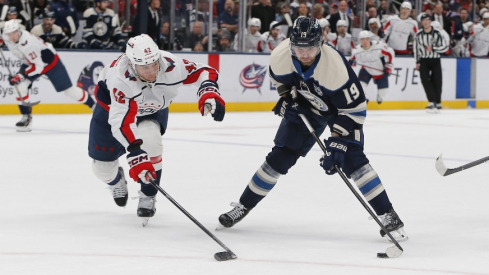Oct 24, 2025; Columbus, Ohio, USA; Columbus Blue Jackets center Adam Fantilli (19) carries the puck as Washington Capitals defenseman Martin Fehervary (42) defends during the second period at Nationwide Arena.