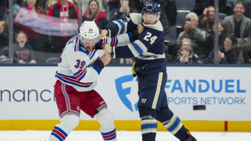 Nov 15, 2025; Columbus, Ohio, USA; New York Rangers center Sam Carrick (39) fights Columbus Blue Jackets right wing Mathieu Olivier (24) in the second period at Nationwide Arena.