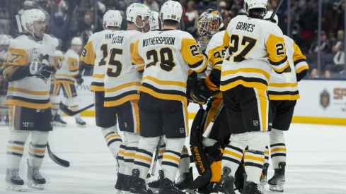 Nov 28, 2025; Columbus, Ohio, USA; Pittsburgh Penguins goaltender Tristan Jarry (35) celebrates with teammates after his team’s win against the Columbus Blue Jackets in the overtime period at Nationwide Arena.