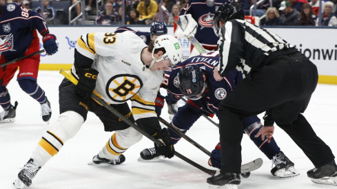 Apr 12, 2026; Columbus, Ohio, USA; Boston Bruins center Fraser Minten (93) and Columbus Blue Jackets center Adam Fantilli (19) face-off during the second period at Nationwide Arena.