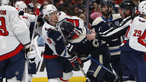 Apr 14, 2026; Columbus, Ohio, USA; Washington Capitals right wing Ryan Leonard (9) pulls Columbus Blue Jackets center Isac Lundestrom (21) away from the crease during the second period at Nationwide Arena.