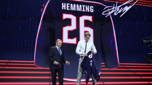 Jun 26, 2026; Buffalo, New York, USA; Oscar Hemming reacts beside NHL commissioner Gary Bettman after being selected with the fourteenth pick in the first round of the 2026 NHL Draft by the Columbus Blue Jackets at KeyBank Center. Mandatory Credit: Timothy T. Ludwig-Imagn Images