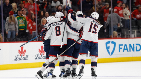 Apr 7, 2026; Detroit, Michigan, USA; Columbus Blue Jackets center Charlie Coyle (3) receives congratulations from teammates after he score on Detroit Red Wings goaltender John Gibson (36) during shoot out to win the game against the Detroit Red Wings at Little Caesars Arena. Mandatory Credit: Rick Osentoski-Imagn Images