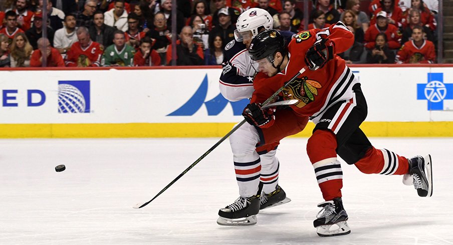 Chicago Blackhawks left wing Artemi Panarin fights for a puck against Columbus Blue Jackets defenseman Seth Jones.