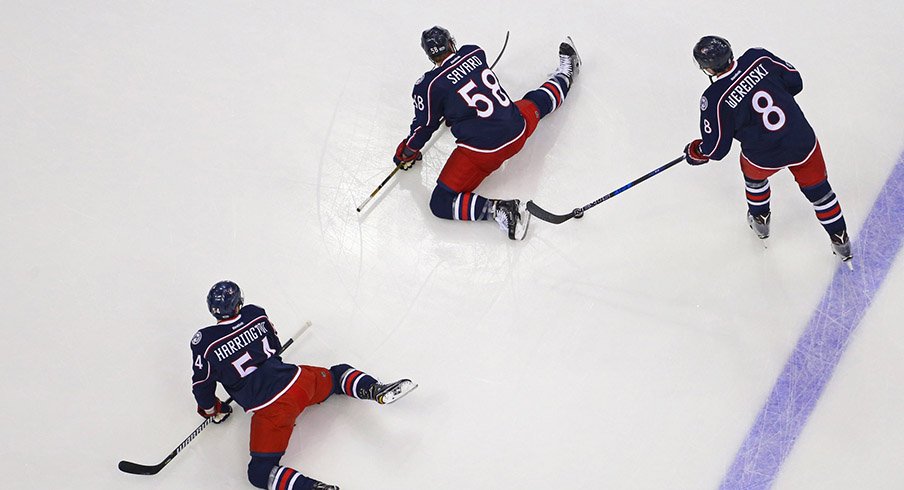 Columbus Blue Jackets defenseman Scott Harrington (54), defenseman David Savard (58), and defenseman Zach Werenski (8).