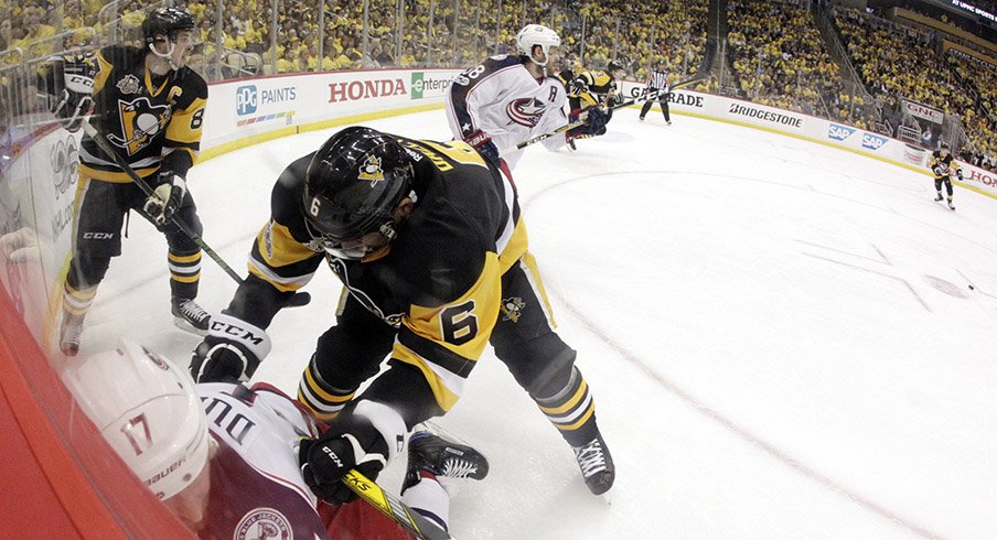 Pittsburgh Penguins defenseman Trevor Daley checks Columbus Blue Jackets center Brandon Dubinsky in the corner during the first period in game one of the first round of the 2017 Stanley Cup Playoffs.