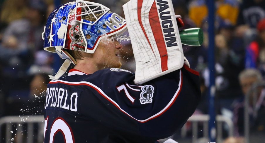 Joonas Korpisalo splashes water on his face before play resumes.