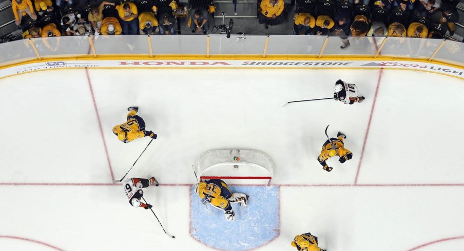 Pekka Rinne attempts to make a save against Richard Rakell