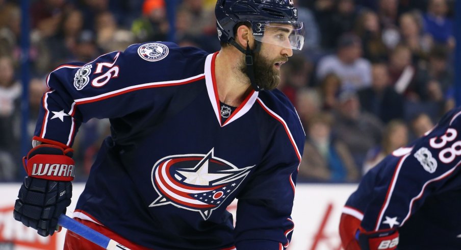 Kyle Quincey gets ready for the puck before a face-off.