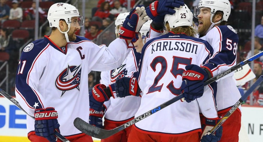 Multiple Blue Jackets including William Karlsson celebrate after scoring a goal