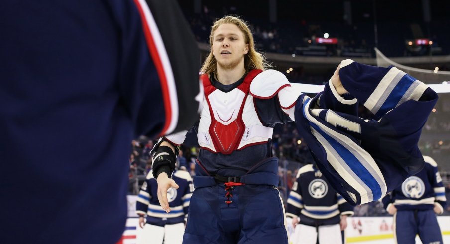William Karlsson removes his jersey as the team gives their jerseys off of their backs.