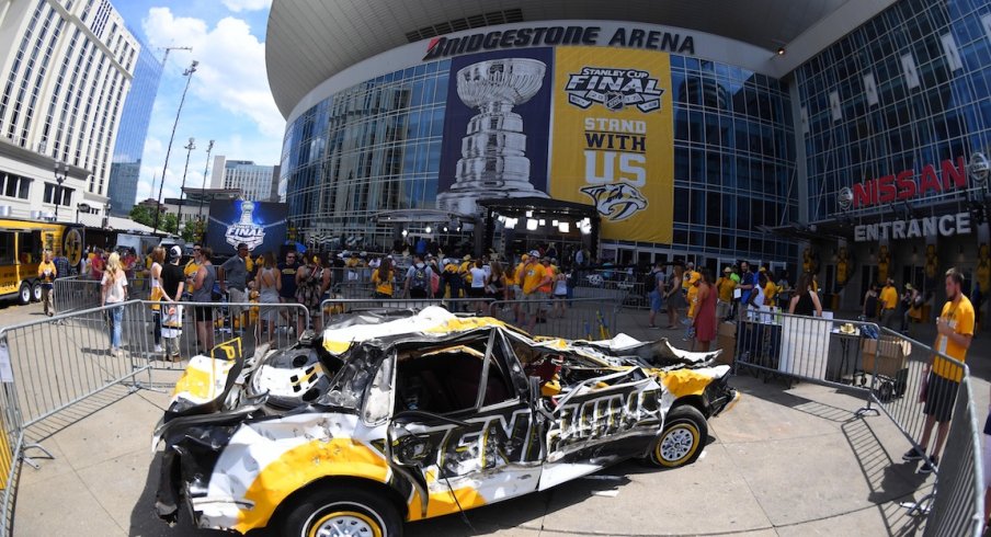 Outside of Bridgestone Arena, Predators' fans beat up on a Penguins car