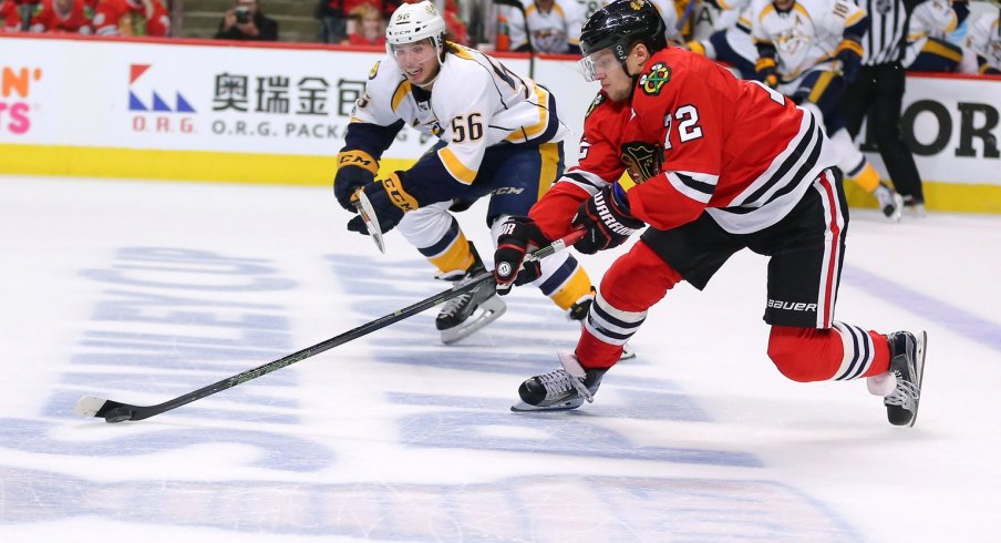 Artemi Panarin skates up the ice with the puck against the Nashville Predators