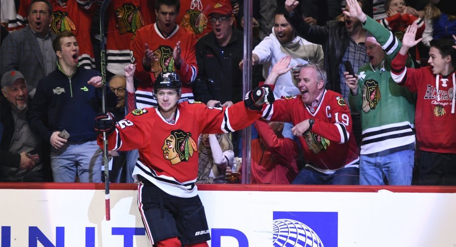 Artemi Panarin celebrates with fans at the United Center