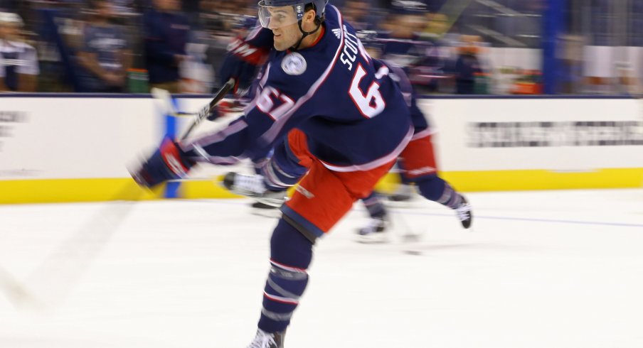 Justin Scott takes a shot during warmups before facing the Blues